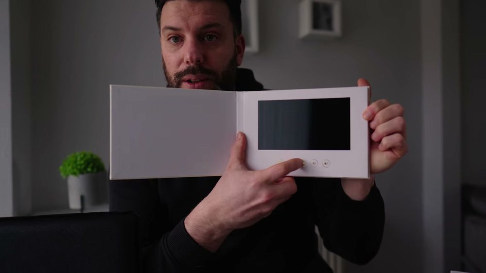 The ADHD Memory Book held open in two hands, showing its size.